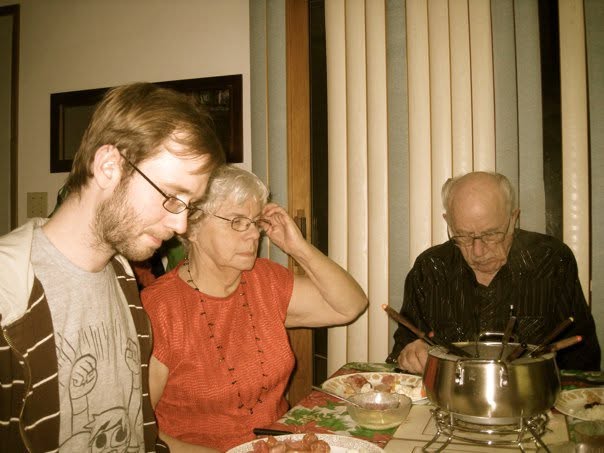 Myself, my granny and papa, at the kitchen table of my childhood home, 2010